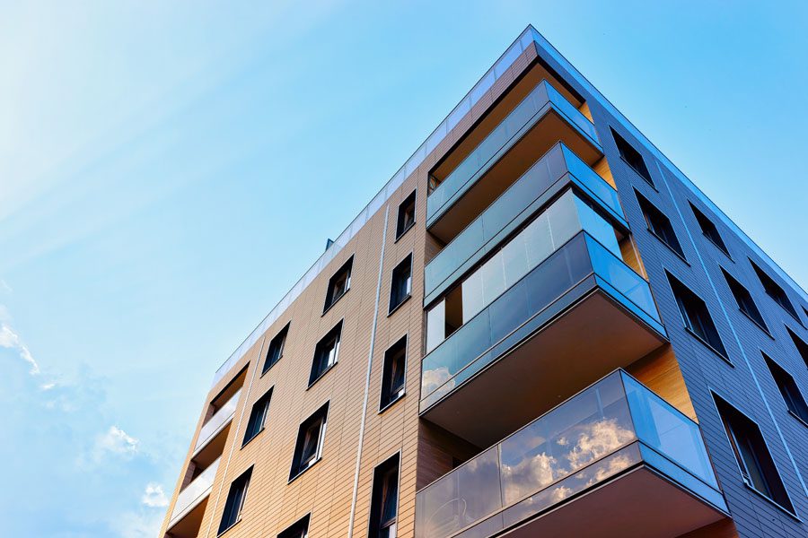 Business Insurance - Modern Apartmenet Building Reflecting Off the Sun